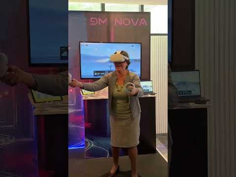 Visitor trying a VR experience at the DM NOVA booth